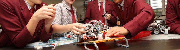 Students assemble robotic LEGO vehicles