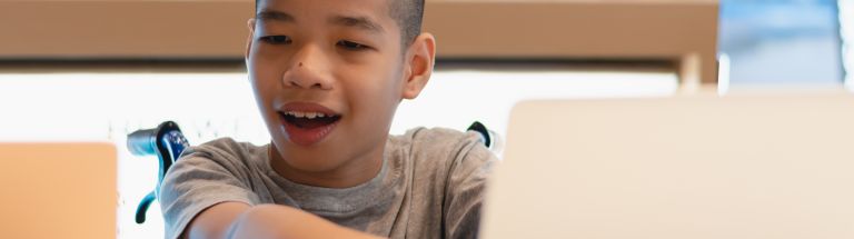 Child in wheelchair at computer