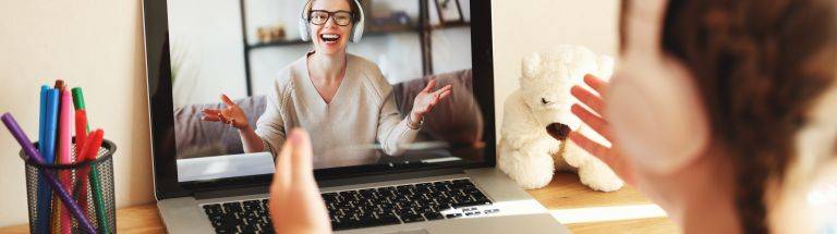 Teacher working with students via computer