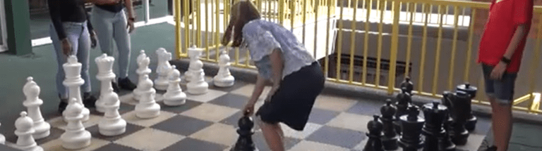 Students playing giant chess