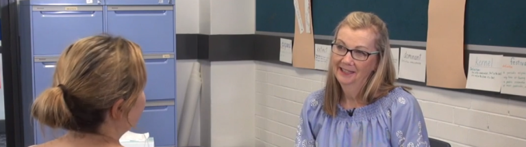 Teacher in conversation with a parent at school