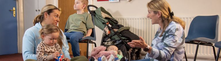 An early childhood educator talks with a parent