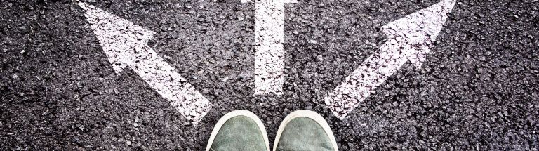 Person standing with 3 arrows on the ground