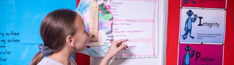 Child reads a visual schedule