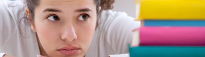 Student looking uninterested, resting chin on hands
