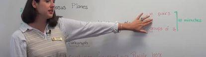 Teacher pointing to writing on a whiteboard