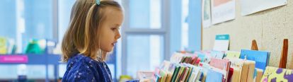Young girl choosing a book to read