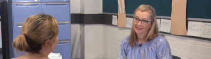 Teacher in conversation with a parent at school