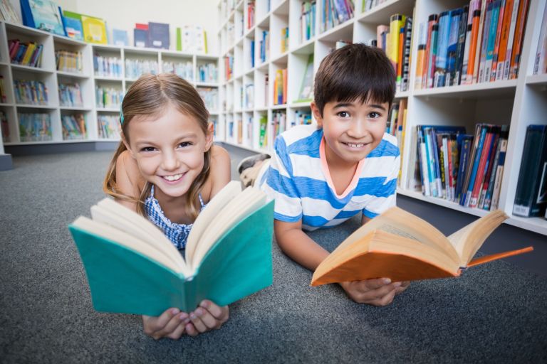 Children reading books in a library