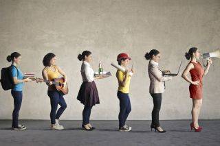 Students in a line, each personifying a different career, e.g. musician, waiter, construction worker